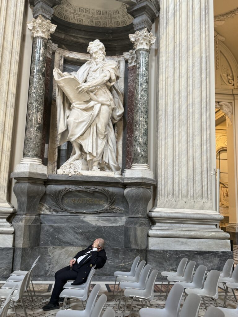 Statue of St. Matthew- foot on a bag of coins